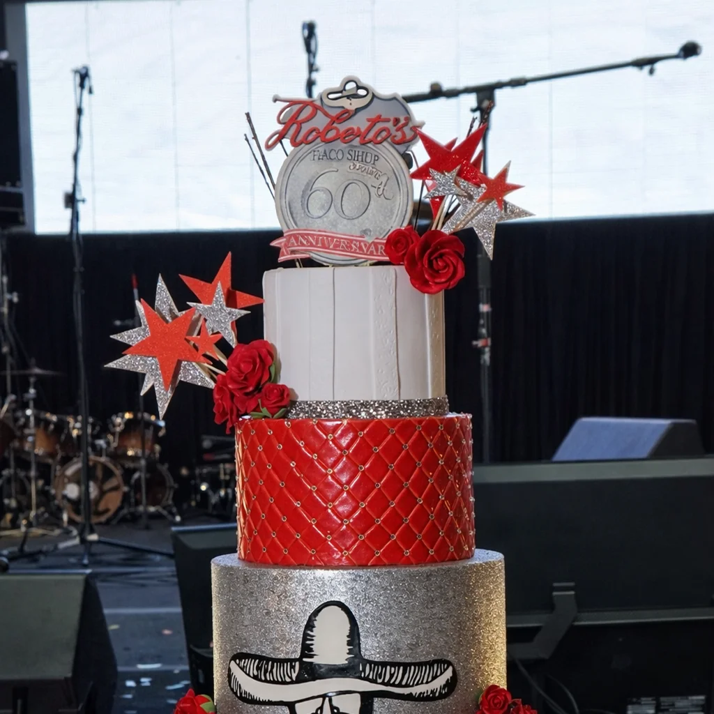 Celebration cake display at Roberto’s Taco Shop event
